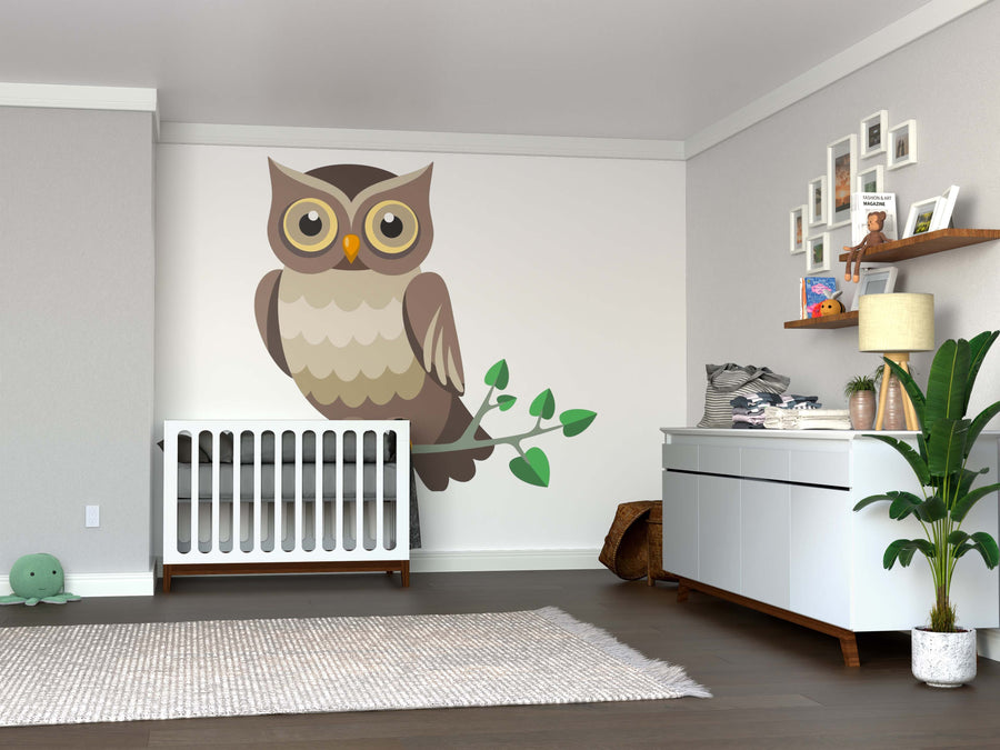 A nursery with a white crib, the Vector Owl Wall Mural, a changing table topped with baby items, a plant in the corner, a rug on the wooden floor, a turtle-shaped toy, and shelves holding books and decor above the changing table.