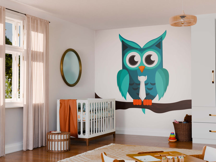 A nursery with a white crib, orange bedding, and a circular mirror. Above the crib is the Owl with Tie Wall Mural showing a blue owl on a branch. A woven basket, toy bin, and rug sit on the wooden floor with light from sheer curtains.