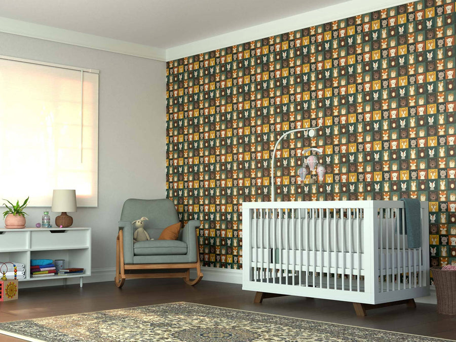 A nursery featuring the Playful Animal Faces Wall Mural, a white crib with a mobile, a rocking chair holding a teddy bear, shelves with books and lamp, window blinds, and a patterned rug on the wooden floor.
