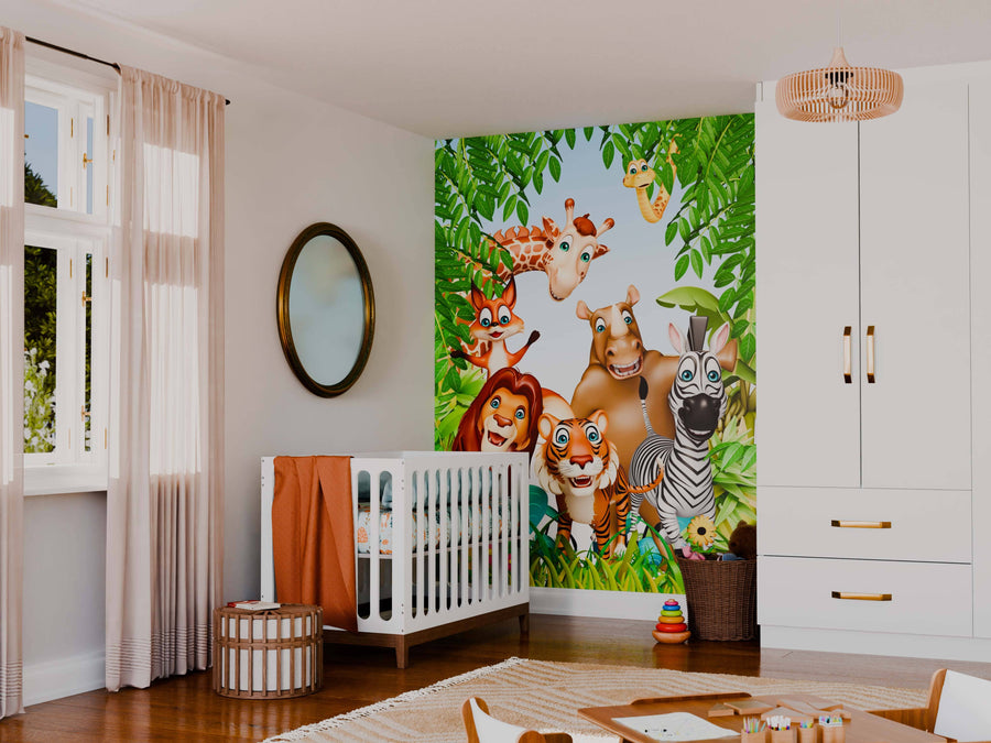 A nursery features the Playful Wild Friends Wall Mural—jungle-themed with cartoon giraffe, monkey, hippo, zebra, lion, and tiger among green leaves—plus a white crib with orange bedding, woven baskets, a round mirror, and wooden floors.