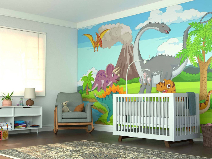 A bright nursery has a crib, armchair with teddy bear, rug, and shelf. Sunlight streams in through blinds while the Prehistoric Island Wall Mural displays cartoon dinosaurs and volcanoes under a blue sky.