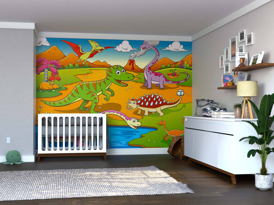 A nursery featuring the Prehistoric Party Wall Mural with cartoon dinosaurs and a volcano, a white crib, dresser with plant, toys, books, framed photos on shelves, hardwood floors, and a gray and white rug.