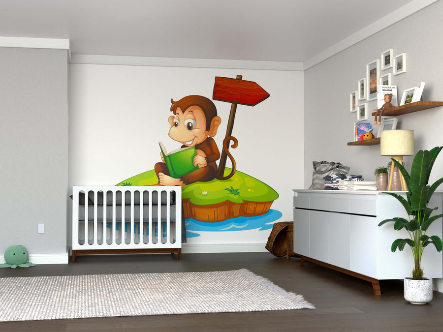 A nursery room includes a crib, dresser, and shelves. The wall is adorned with the Reading Monkey Wall Mural featuring a cartoon monkey on a grassy island with a red signpost. Gray decor, toys, and framed photos add to the cozy vibe.