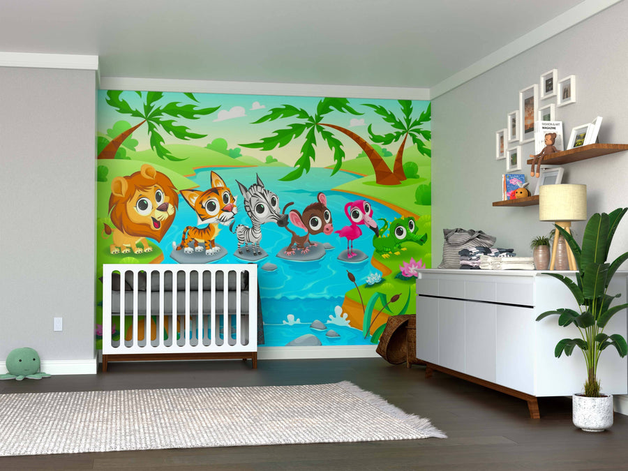 A nursery features a white crib and dresser. A River Crossing Friends Wall Mural with cartoon animals—a lion, fox, zebra, monkey, flamingo, and frog by a pond—adds color and cheer to the room's atmosphere.