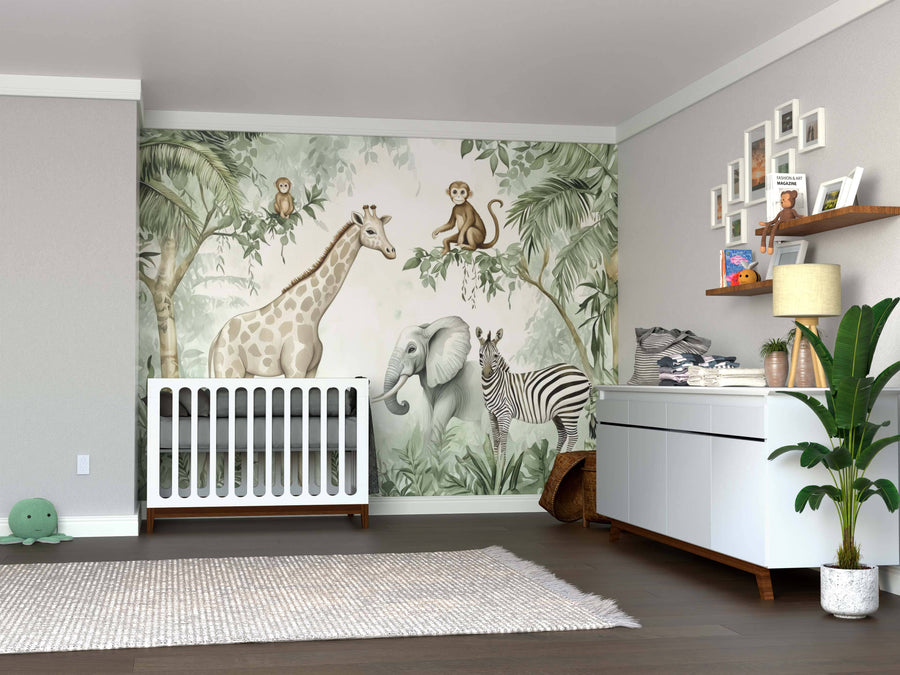 A nursery with a crib, changing table, and Safari Friends Wall Mural featuring jungle animals. The room includes a soft rug, toy shelves, framed photos, a large potted plant, and hardwood floors.