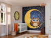 A nursery with a crib, wicker basket, toys, and a round mirror. The feature wall displays the "Starry Night with Owl Wall Mural," showing a yellow crescent moon, stars, and an owl. Sunlight from the window brightens the playful space.