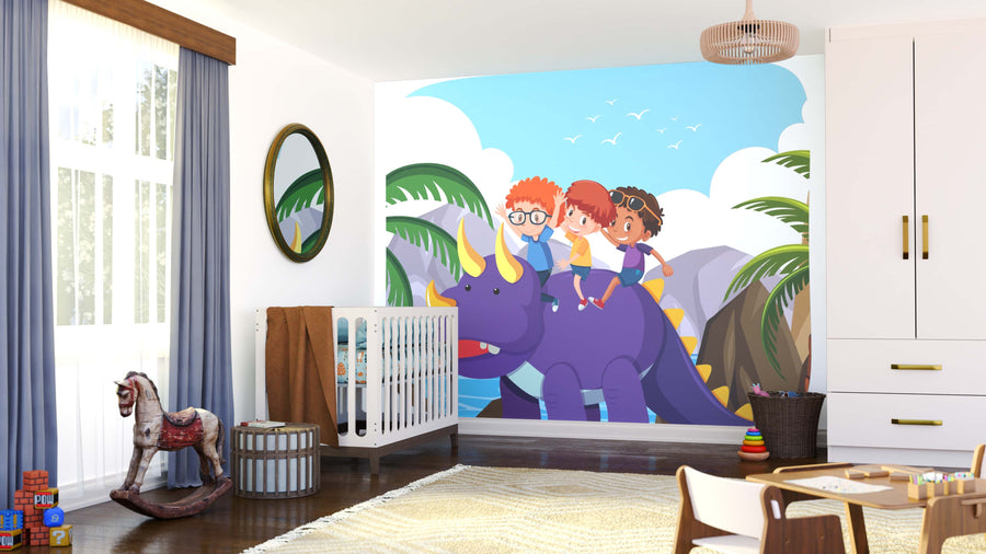 A bright, modern nursery features a crib and toys. The wall displays the Triceratops Adventure Ride Wall Mural, showing three cartoon kids on a friendly purple dinosaur with yellow horns among palms and mountains under a blue sky.