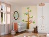 A cozy nursery with a white crib, round mirror, and wicker basket. The wall features the Two Owls on the Tree Wall Mural—one blue and one pink owl on branches. Soft curtains frame the window; toys are stacked in the corner.