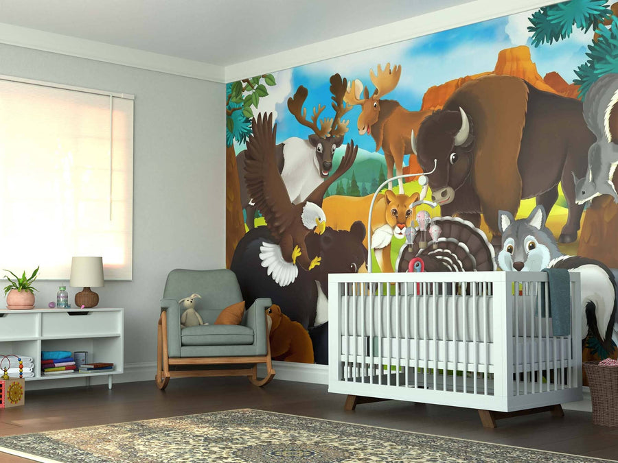 A cozy nursery with a crib and armchair features the Wildlife Harmony Wall Mural, displaying cartoon forest animals like a bison, moose, eagle, fox, beaver, wolf, and rabbit. A soft rug, toys, lamp, and book-filled shelves add warmth.