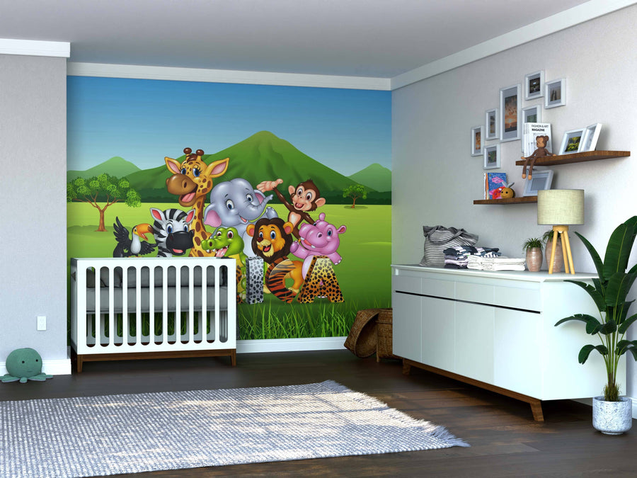 A nursery with a white crib is set before the vibrant Wildlife of Africa Wall Mural, featuring cartoon jungle animals on green hills. A dresser, potted plant, and photo frames add cozy touches to the cheerful space.