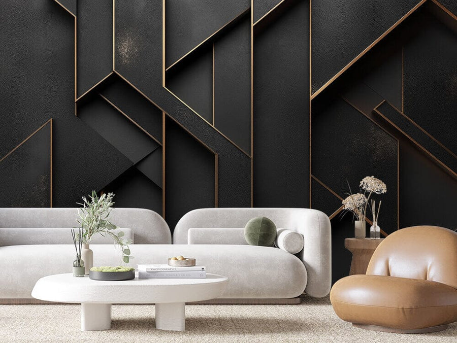 The modern living room features an Obsidian Grid Wall Mural in black and gold. Two white sofas with green and gray pillows surround a white oval coffee table with books and a green plant. A brown chair complements the look, while a round wooden side table with dried flowers and a beige carpet add warmth.