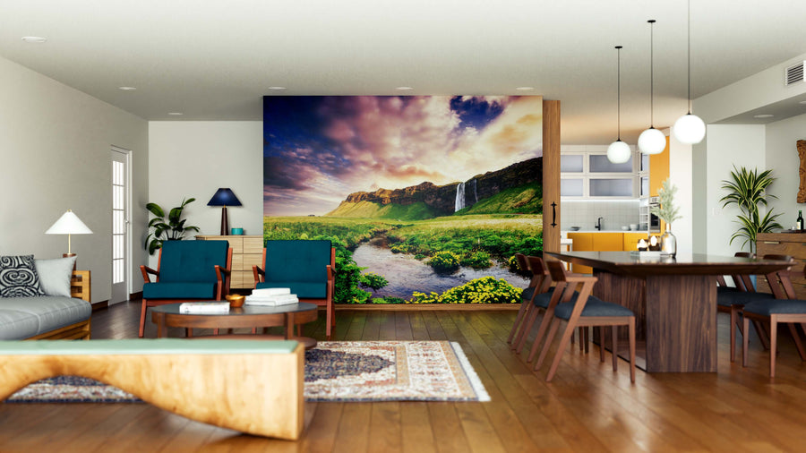 A modern open living and dining area features hardwood floors, contemporary furniture, and a Picturesque Landscape Wall Mural of lush green mountains and a waterfall, adding vibrance to the room’s neutral color palette.