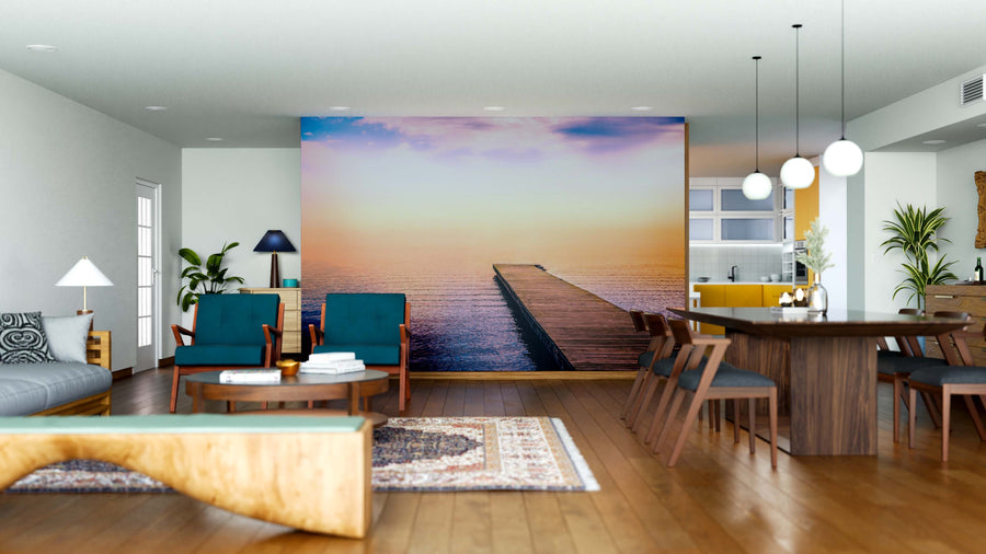 Modern open-plan living and dining room with wood floors, mid-century furniture, pendant lights, and the Pier in the Sea Wall Mural as a tranquil, easily updated focal point thanks to its removable peel and stick design.