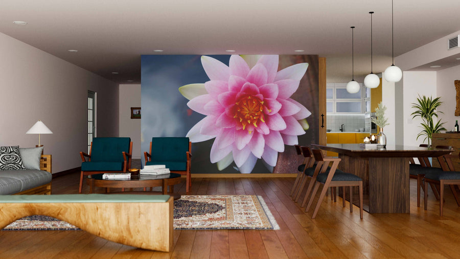 A modern living-dining room with wood floors, contemporary furniture, rugs, and a striking Pink Lotus Wall Mural. The dining area features a wooden table, chairs, pendant lights, and an open, inviting atmosphere.