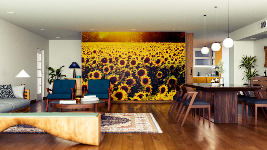 A modern open-concept living and dining area features wooden floors, mid-century furniture, and the Radiant Sunflower Horizon Wall Mural, adding vibrant color and warmth to the stylish, well-lit space with large windows.