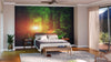 A cozy bedroom features the "Railway in The Spring Forest Wall Mural" behind the bed. Modern furniture, wooden floors, soft neutrals, a large window, and lush plant combine to create a warm and inviting atmosphere.