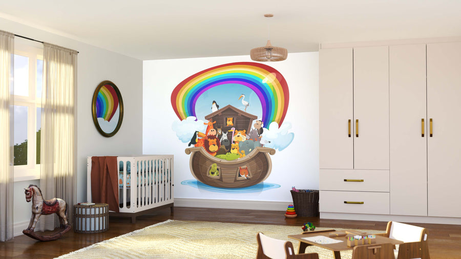 A bright nursery with a crib, rocking horse, toys, and a large Rainbow Ark Wall Mural. Sunlight streams through the window, illuminating the cozy, organized room and its colorful mural of animals under a rainbow.