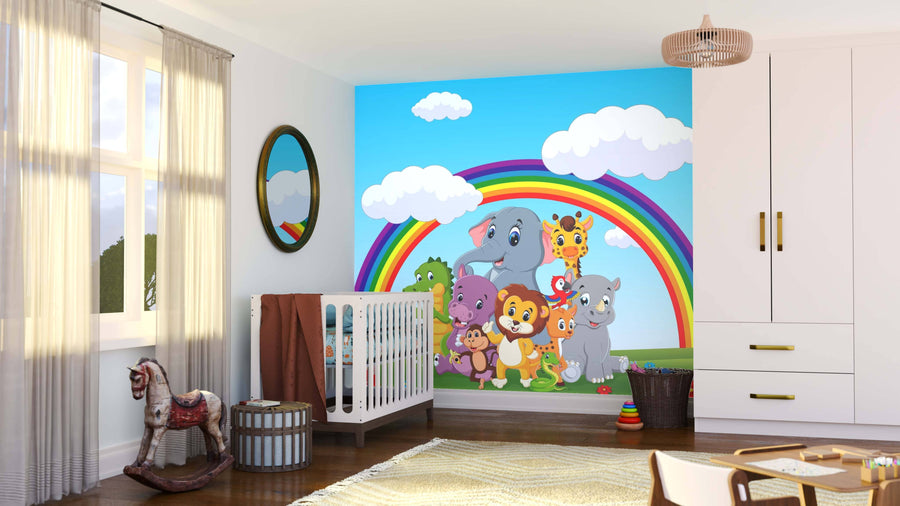 A bright nursery with white walls and light wood flooring features the Rainbow Jungle Friends Wall Mural. The room includes a crib, rocking horse, round basket, and a window with beige curtains.