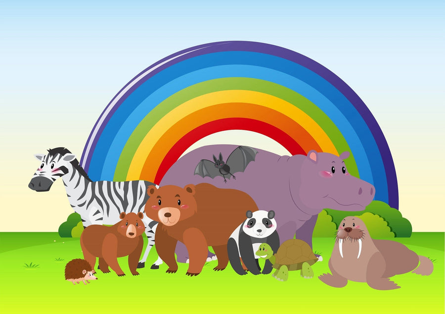 A nursery features a crib, plush toys, and the Rainbow Wildlife Wall Mural with cartoon animals. A white shelf for books and decor stands by a cushioned chair, window, and patterned rug on dark wood floors.