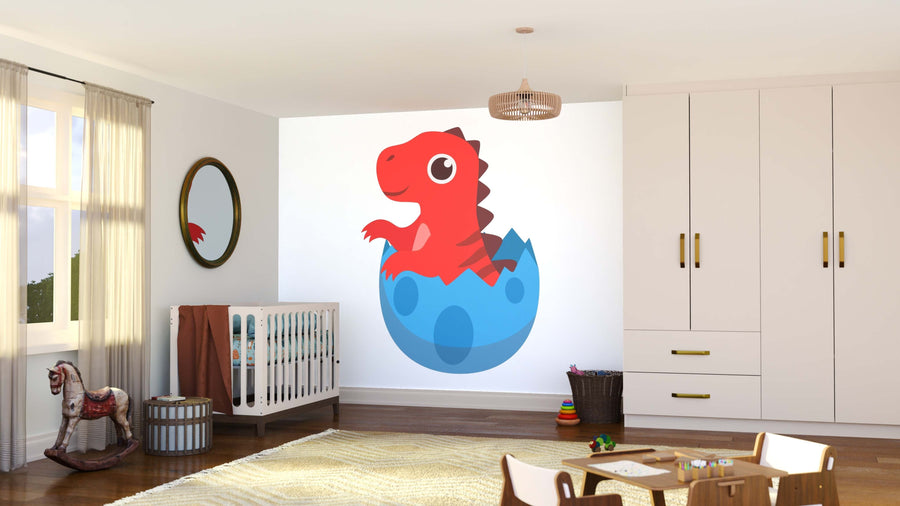 A children’s bedroom features a crib, toy rocking horse, and storage units. The Red Dino Hatching Wall Mural—a colorful peel and stick mural of a smiling red cartoon dinosaur—decorates the wall, while sunlight through sheer curtains brightens the space.