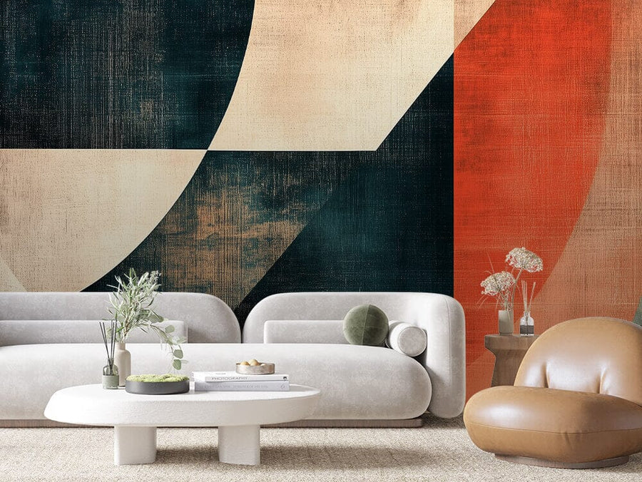 A modern living room features two white curved sofas with green pillows, a white oval coffee table with plants, and a round brown leather chair. The highlight is the Retro Geometry Wall Mural with geometric shapes in beige, dark green, and orange tones.