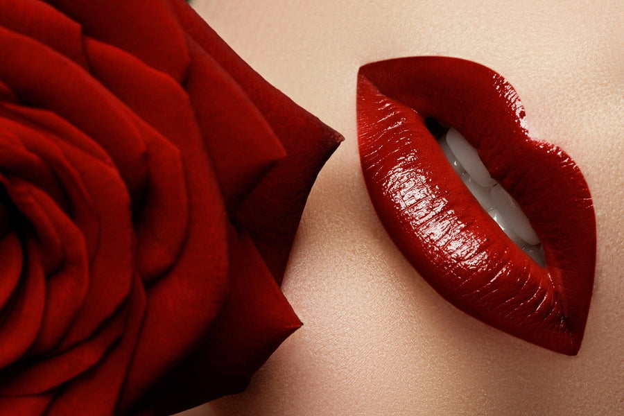 The Sexy 5 Wall Mural features a close-up of glossy red lips slightly parted to reveal white teeth, set against a vibrant red rose. The smooth, light skin contrasts with the deep shades of the lips and rose, highlighting their richness and echoing the mural's custom print design.