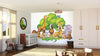A bright nursery features the Safari Animal Party Wall Mural with lions, giraffes, zebras, and elephants under trees. The room includes a crib, rocking horse, toys, round mirror, light wood floors, and large windows with sheer curtains.