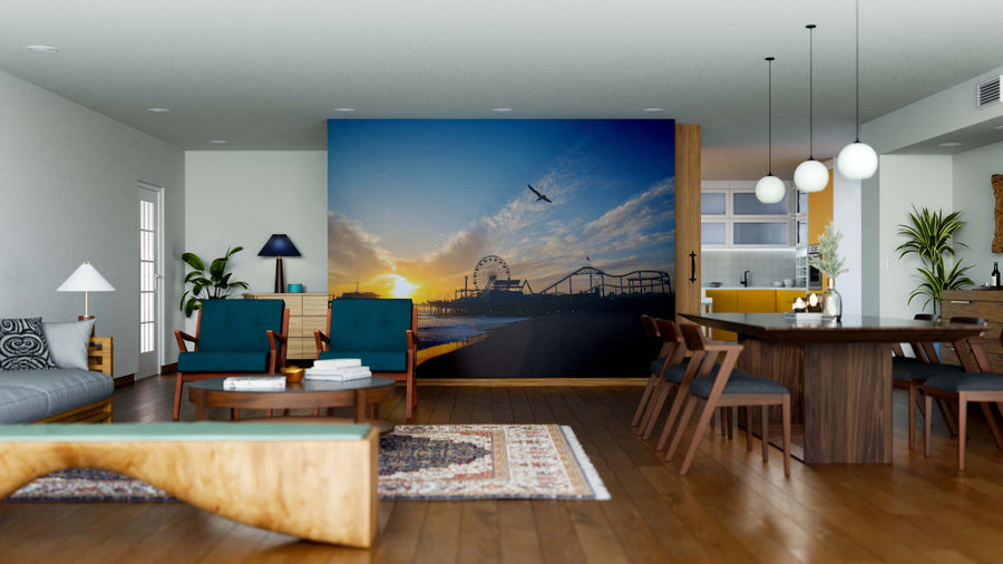 A modern open-plan living and dining room with wood floors and contemporary furniture features the striking Santa Monica Pier Wall Mural. Natural light fills the space, accentuating the stylish, inviting decor.