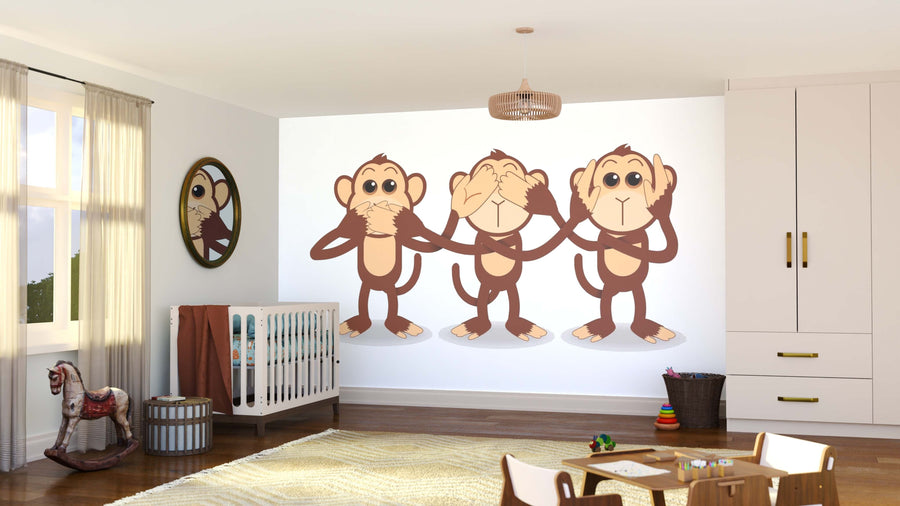 A bright nursery showcases the See No Evil Trio Wall Mural, featuring three cartoon monkeys with "see no evil, hear no evil, speak no evil" gestures. Sunlight streams in over the crib, toys, and rug for a playful touch.