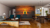 A modern open-plan living and dining area with wooden floors features the "Silhouette of Buddha During Sunset Wall Mural" on the main wall, its orange clouds creating a peaceful, calming focal point.