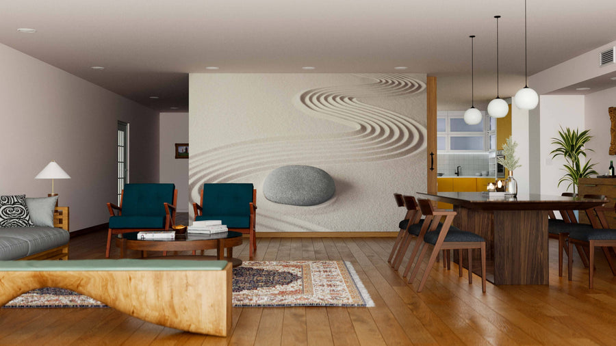 A modern open-plan living and dining area with wooden floors, teal chairs, and a gray sofa features the Spiritual Zen Meditation Wall Mural with sand patterns and a stone, adding a zen touch. Warm lighting and rustic décor complete the look.