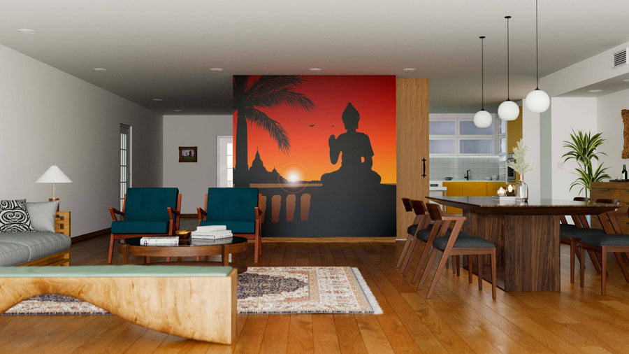 A modern living-dining area with wooden floors, blue armchairs, and a round coffee table showcases the Statue of Buddha Wall Mural at sunset. The dining space has dark chairs, globe pendant lights, and the kitchen is seen in the background.