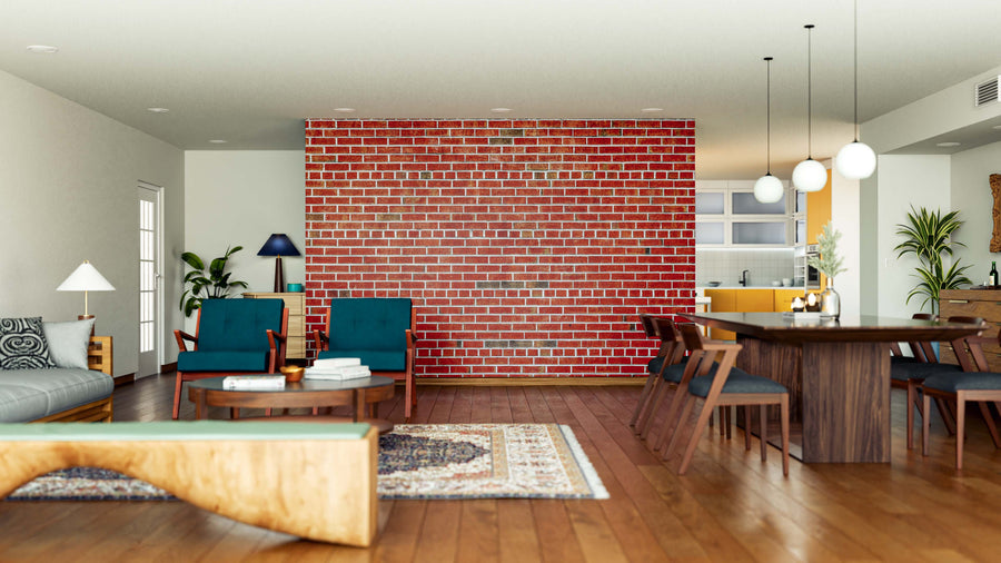 A modern open-plan living and dining room features a red brick accent wall created with the Straight Brick Lines Wall Mural, wooden floors, green armchairs, a gray sofa, patterned rugs, a wooden table with chairs, pendant lights, and large windows.