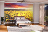 A bright bedroom features the Summer Sunflower Field Wall Mural behind the bed with white and gray bedding. Wooden nightstands, lamps, a bench, a potted plant, sheer curtains, and hardwood floors decorate the sunny space.