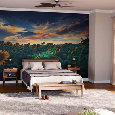 A modern bedroom showcases "A Beautiful Sunflower Field Wall Mural" behind the bed, complemented by light walls, wooden furniture, a soft rug, and sheer curtains on floor-to-ceiling windows for an airy, inviting feel.