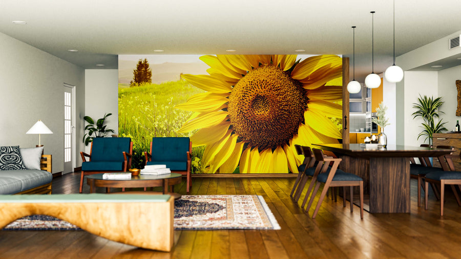 A modern living and dining room features wood floors, blue armchairs, a large Sunflower Landscape Wall Mural, a dining table with wooden chairs, pendant lights, a natural wood edge bench, accent rugs, and an airy, inviting atmosphere.