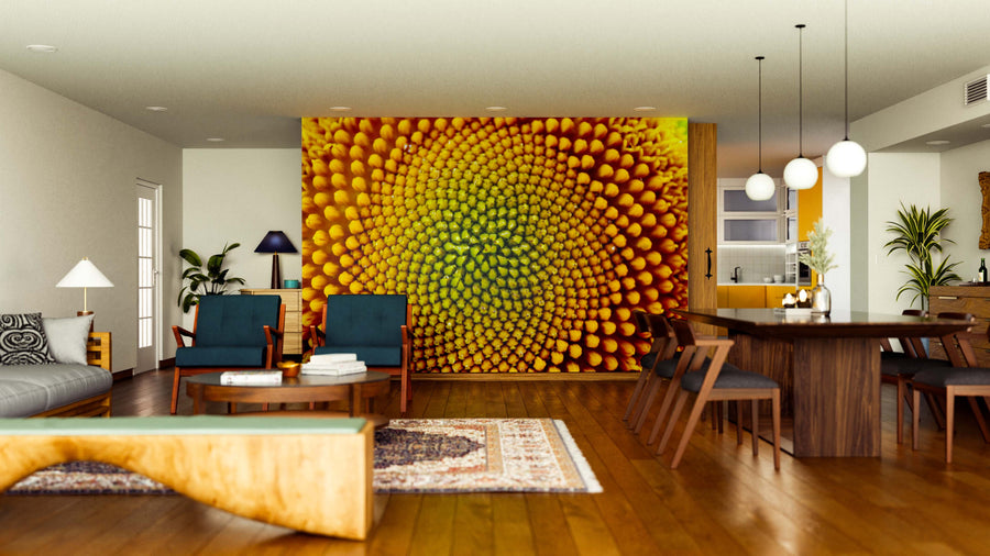 A modern living-dining room features wood floors, mid-century furniture, a rug, and the Sunflower's Golden Core Wall Mural, which adds bold, vivid yellow and green tones to the spacious, elegantly decorated interior.