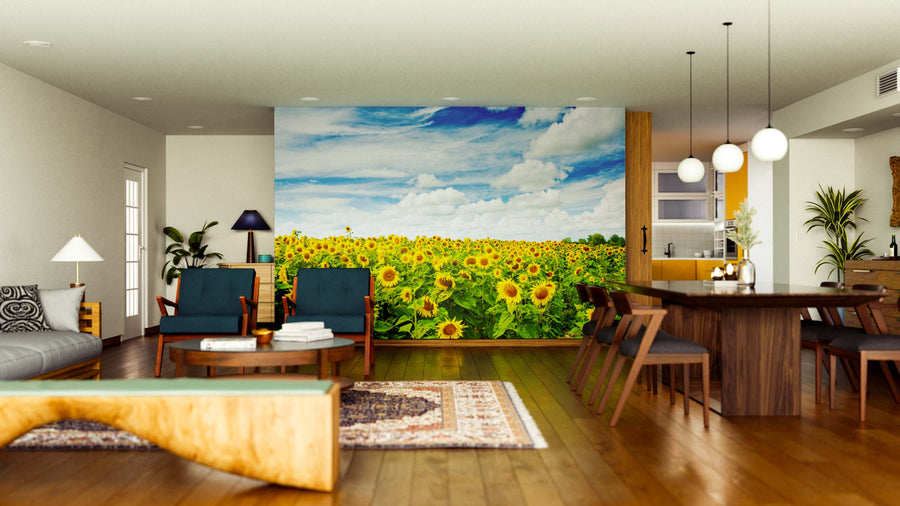 A modern, open-plan living and dining room features wood floors, stylish furniture, and the Sunflowers in Summer Wall Mural, which showcases a sunny field of blooming sunflowers under a blue sky for a vibrant, natural focal point.
