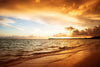 A stunning sunrise over the Atlantic Ocean, casting a warm glow on the sandy beach – Peel and Stick Wall Murals