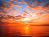 Sunset at the sea, casting a warm golden glow on the horizon – Peel and Stick Wall Murals