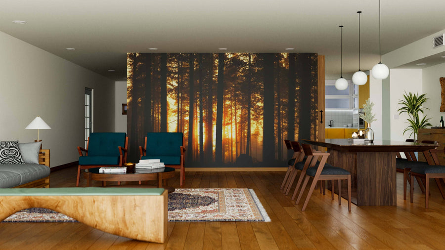 A modern open living-dining area with wood floors and furniture features the Sunset in Dark Foggy Forest Wall Mural. Blue armchairs, a wooden coffee table, and a dining set complete the cozy, warmly lit space.