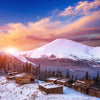 Scenic view of a mountain cottage at sunset with colorful sky