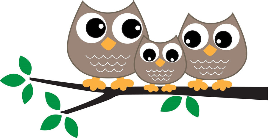 A modern nursery with a white crib and dresser, plant, toys, floating shelves for photos and books, wood floors, neutral walls, and the Sweet Owl Family Wall Mural featuring three cartoon owls on a branch above the crib.