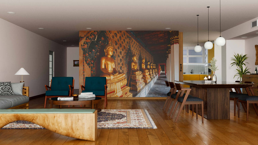 A modern living-dining area with wood flooring, teal chairs, eclectic decor with rugs and plants, a wooden dining table under pendant lights, and a large custom Thailand Buddha Wall Mural depicting golden statues in an ornate corridor.
