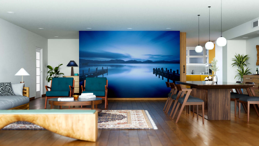 Modern open-plan living and dining room with wood furniture, plants, and pendant lights features the Two Wooden Jetty Wall Mural—a stunning lake scene at dusk that creates a calming focal point and transforms the atmosphere.