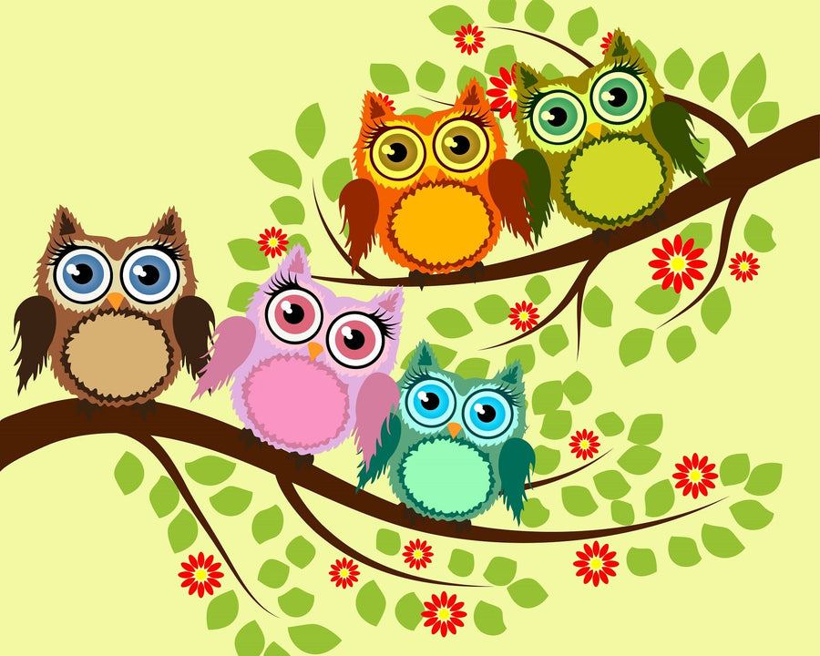 A nursery room features the Vibrant Owl Family Wall Mural—five colorful cartoon owls on a tree branch above a white crib. A dresser, framed photos, plant, and hardwood floors add to the room’s bright and playful atmosphere.