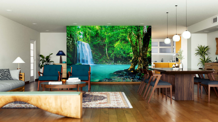 A modern, open-plan living and dining area with wooden floors, mid-century furniture, indoor plants, and a Waterfall in Thailand National Park Wall Mural creates a serene, nature-inspired atmosphere.