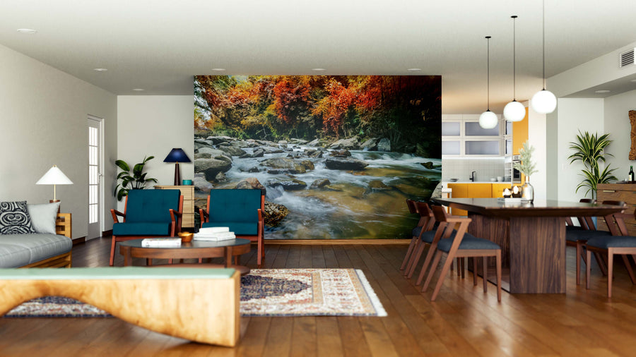 Spacious, modern living-dining room with wood floors and mid-century furniture. The Waterfalls in the Wilderness Wall Mural, blue chairs, and pendant lights combine to create a cozy, inviting atmosphere.