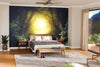 A modern bedroom includes a Way in Deep Forest Path Wall Mural behind the bed, wooden bed, neutral bedding, nightstands with lamps, bench, gray rug, potted plant, and sliding glass doors.