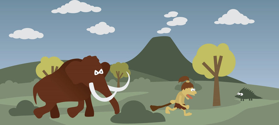 A nursery featuring the Wilderness Run Wall Mural, depicting a cartoon mammoth chasing a person with a spear among hills, trees, and a volcano. The room includes a crib, toys, rocking horse, round mirror, and window with beige curtains.